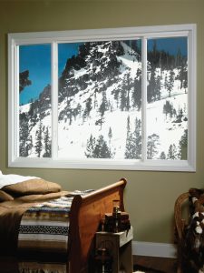 Bedroom with mountains in the window