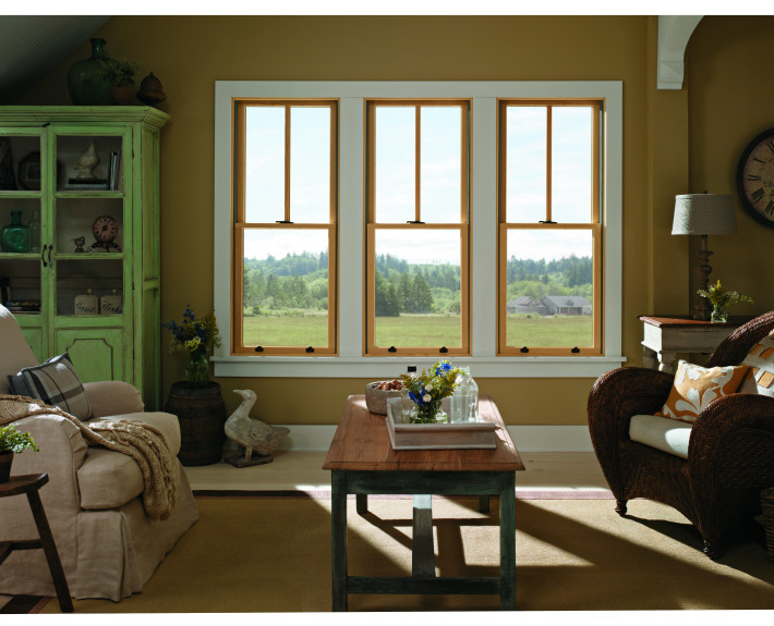 Living room with three new windows looking out to yard