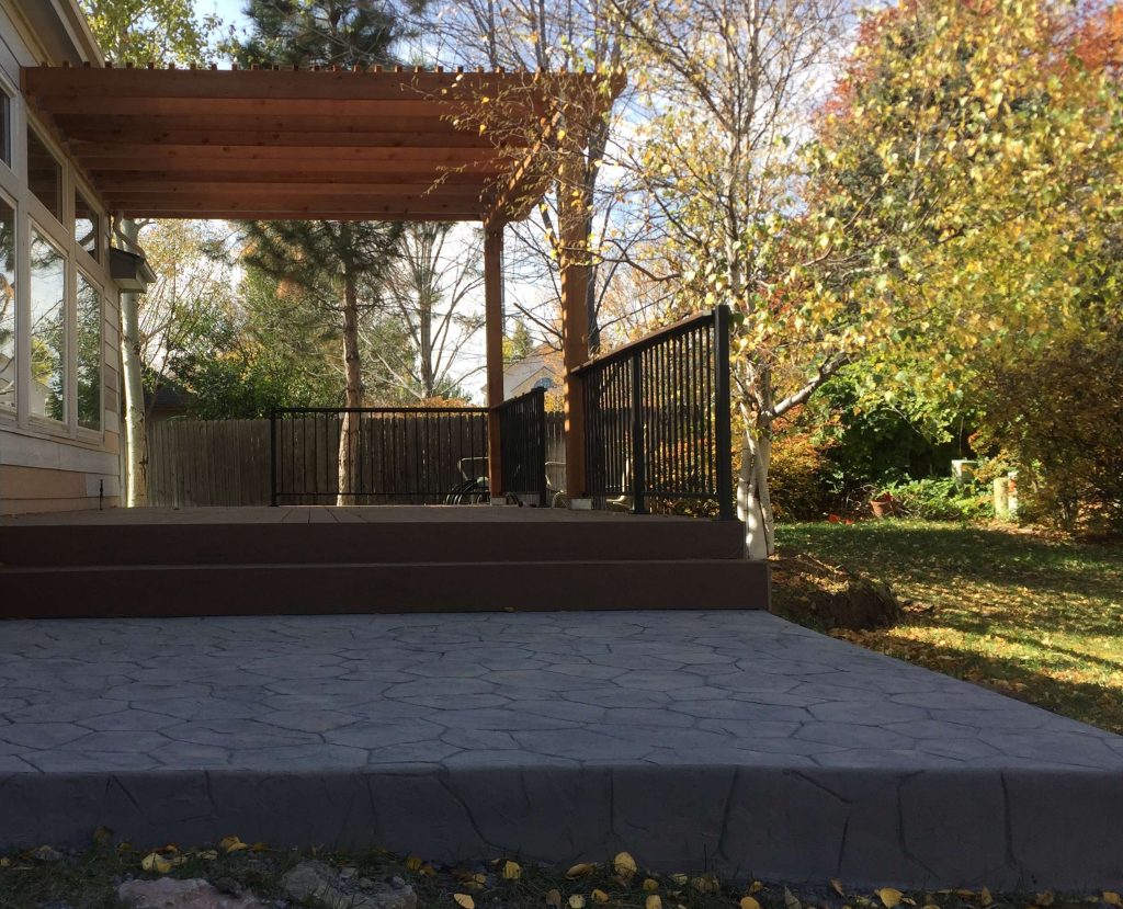 Brown patio with black stamped concrete extension