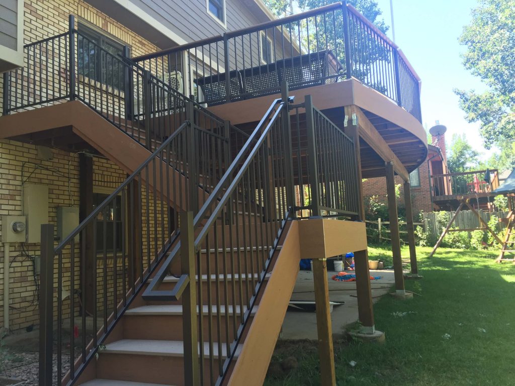 Custom brown second story deck with custom metal railing and stairs