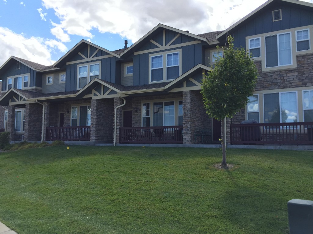 Stone front apartment complex with blue siding