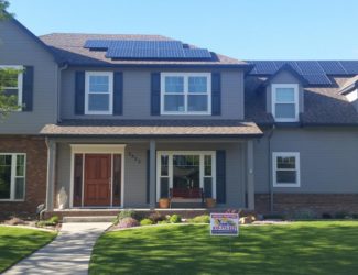 Dark grey house with black shudders