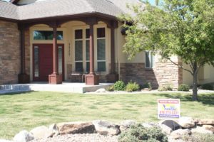Stone entrance to home with Vivax Pros sign in front yard