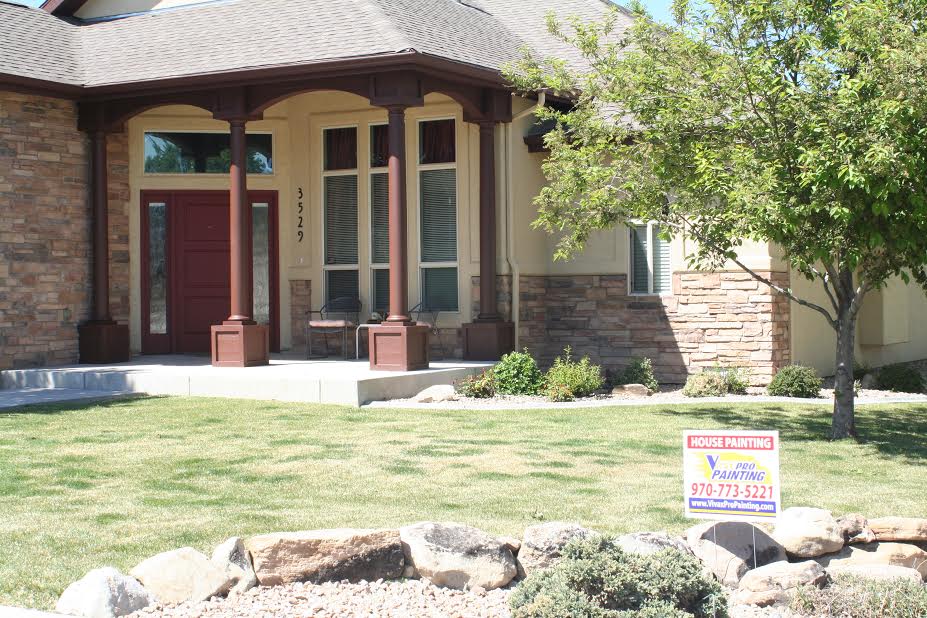 Stone entrance to home with Vivax Pros sign in front yard