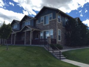 Stone front and blue siding apartment complex