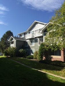 Brick and green siding apartment complex