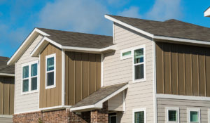 the outside of a residential apartment complex looking at the siding and roof
