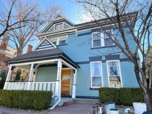 historic looking brick home with new light blue paint Vivax Pros House Painters