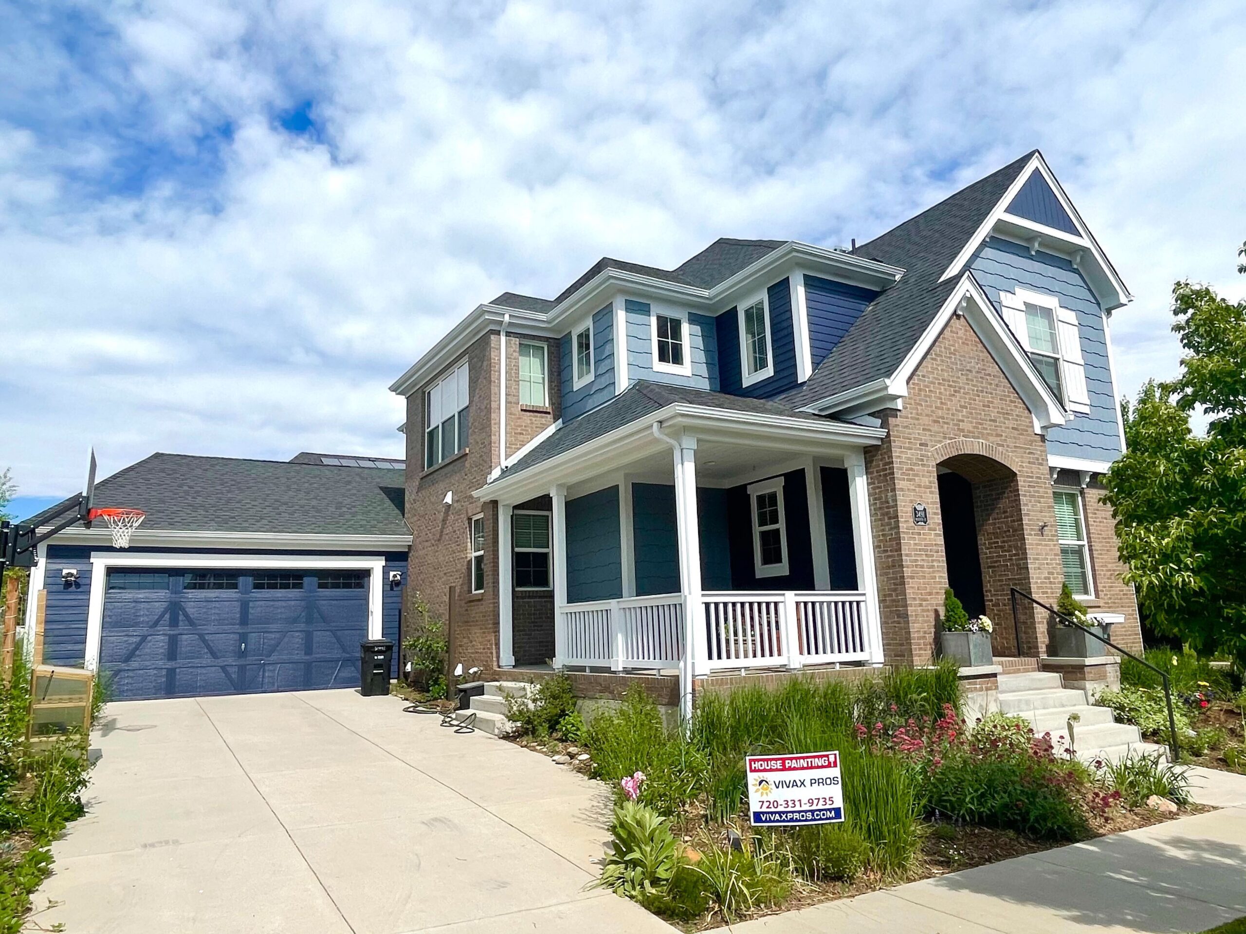 Colorado home with new blue paint job on house and garage Vivax Pros House Painters