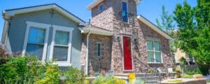 Vivax Pros brick home with red painted door
