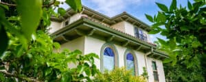 home with oval windows recently painted off white and green Vivax Pros